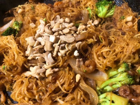 adding cashews to pan