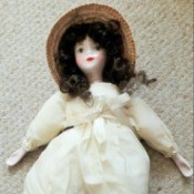 Identifying a Porcelain Doll - doll wearing a period long white dress and a straw hat