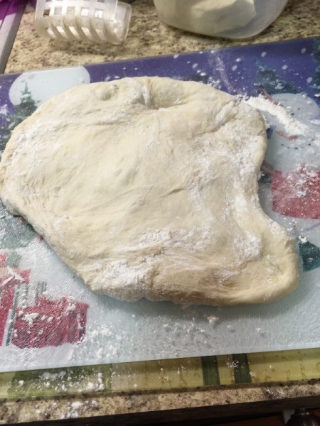 flattened pizza dough