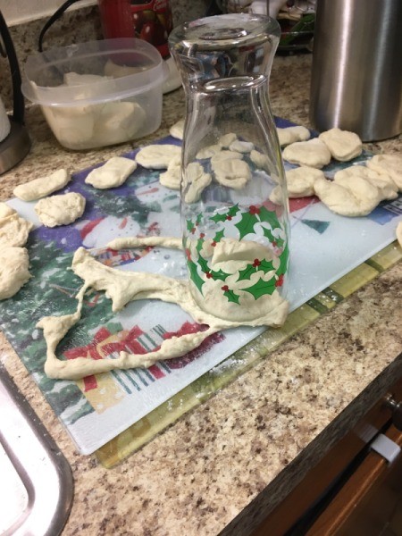cutting circles of dough with glass