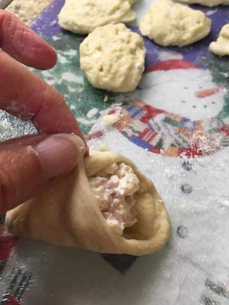 pinching dough together around fillingRolls