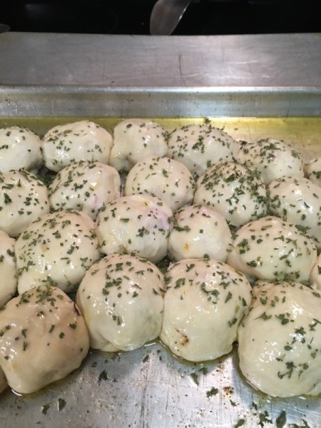 Ham and Cheese Rolls sprinkled with parsley on baking tray
