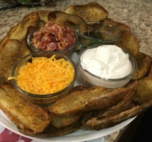 Potato Skins on plate with bowls of toppings