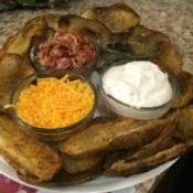 Potato Skins on plate with bowls of toppings