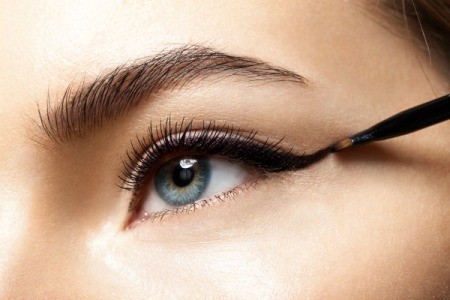 closeup of person applying eyeliner