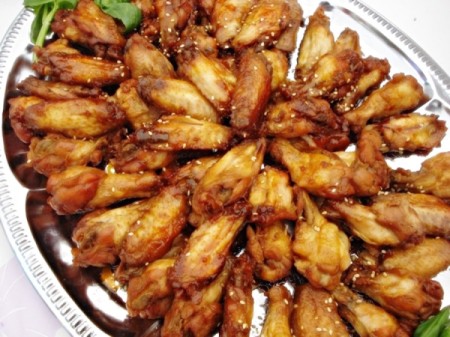 A platter of chicken wings at a potluck wedding.