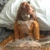 Identifying a Porcelain Doll - doll wearing a gold and lace dress