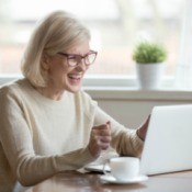 Woman happy at her computer.