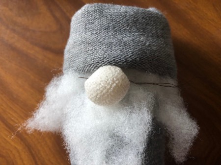 DIY Gnome Dolls - sew the nose onto the sock right below the fold and through the beard