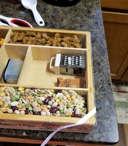 Shadow Box with a Soup Theme - add soup mixes and/or pasta, glue down the ribbon keeping taut until the glue is set