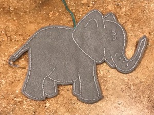 Felt Elephant Ornament - ornament lying on a laminate countertop