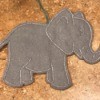 Felt Elephant Ornament - ornament lying on a laminate countertop