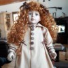 Identifying a Porcelain Doll - doll with long red curly hair and period overcoat