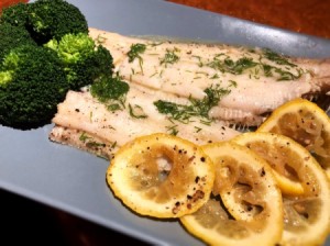 cooked Fish, lemon and broccoli on platter