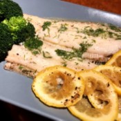 cooked Fish, lemon and broccoli on platter