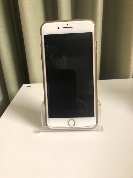 A business card holder being used as a iPhone stand.