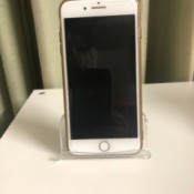 A business card holder being used as a iPhone stand.
