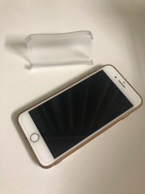 A business card holder next do a iPhone.