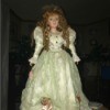 Identifying a Porcelain Doll  - doll wearing a long with dress with ribbon roses