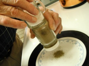 Rubbing salt and pepper shakers end to end to facilitate pouring.