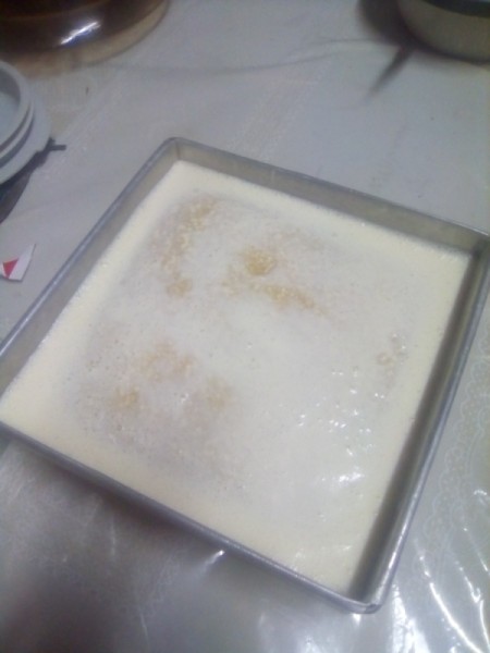 cream on cake batter in pan