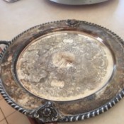 Finding the Value of a Silver Platter - tarnished round ornate silver platter