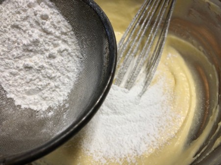 adding flour to batter