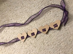 Toddler Birthday Sash - finished sash with 4 hearts strung on purple ribbon