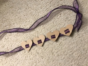 Toddler Birthday Sash - finished sash with 4 hearts strung on purple ribbon