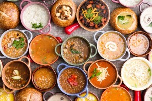 Many bowls of different varieties of soup.