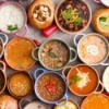 Many bowls of different varieties of soup.