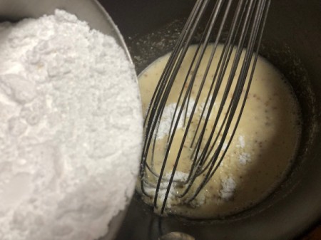 whisking powdered sugar with cooked butter
