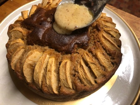 spooning brown butter on cake