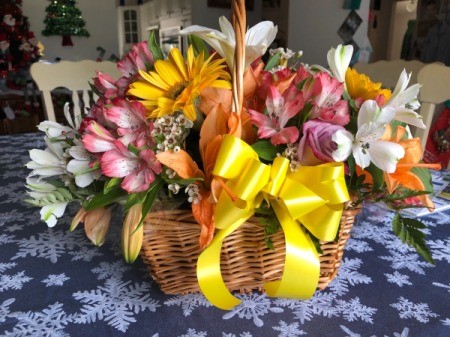 A floral arrangement in a basket.
