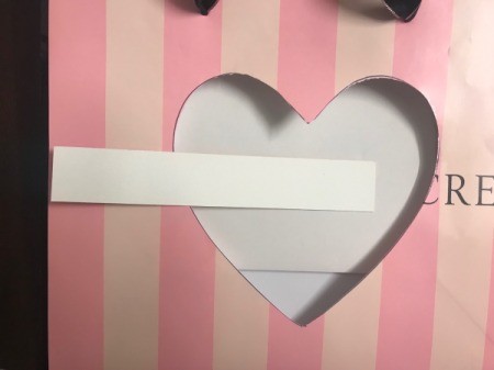 Repurpose Victoria's Secret Shopping Bag for Valentine's Day - adding an arrow shape to cover store name, here part of shaft