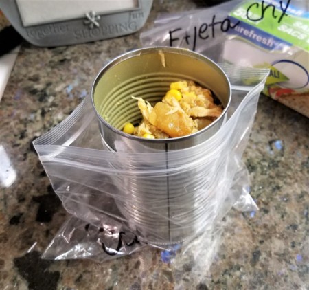 A can inside a ziptop bag, for use in filling.
