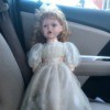 Identifying a Porcelain Doll - doll wearing a long white dress with a pink ribbon sash