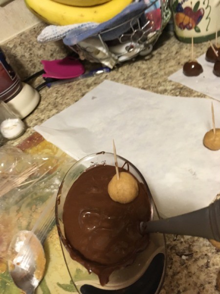 dipping Peanut Butter Balls= in chocolate