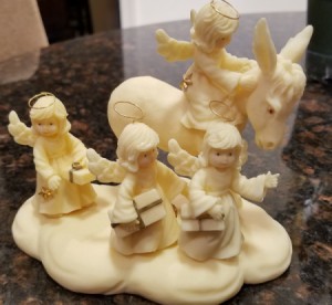 Information on a Tom Rubel Sculpture - ivory colored cast sculpture of 4 angels with one on a donkey