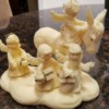 Information on a Tom Rubel Sculpture - ivory colored cast sculpture of 4 angels with one on a donkey