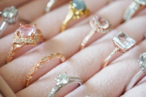 A collection of antique rings displayed on a pink display.