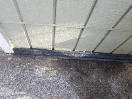 Foam To Fix a Leak in a Store Room - lengths of foam insulation along the lower edge of storage unit