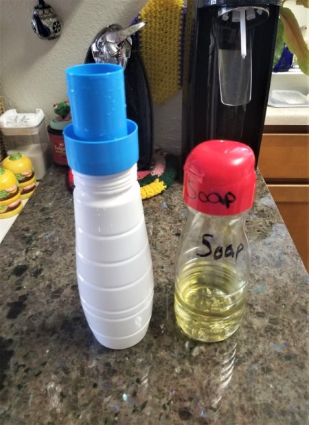 A Soda Stream container repurposed into a container for laundry soap.