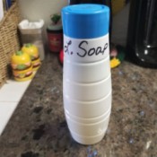 A Soda Stream container repurposed into a container for laundry soap.