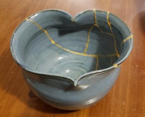 DIY Japanese Kintsugi Pottery Repair - bowl glued back together with web of gold paint showing along the repair lines