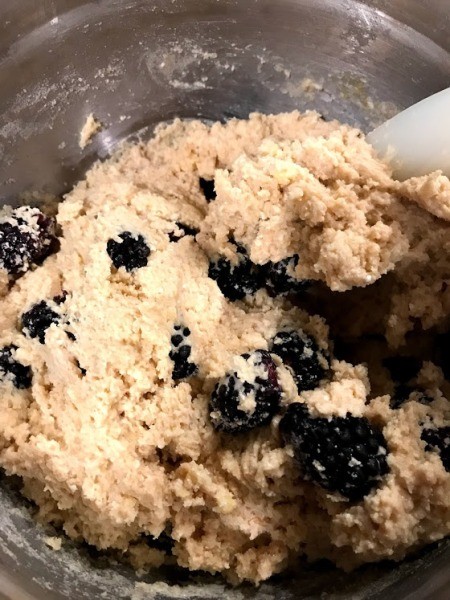 mixing blackberries into batter
