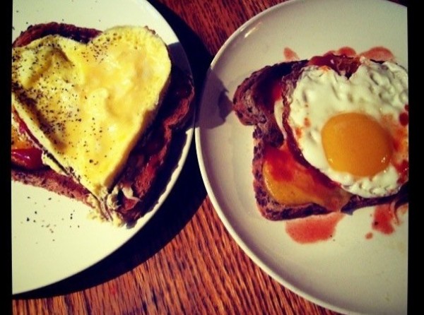 Heart shaped eggs on a plate, to celebrate an anniversary.