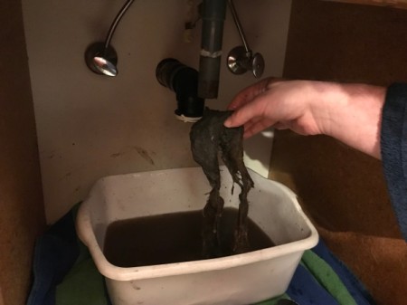 A large wad of hair that has been removed from the drain.