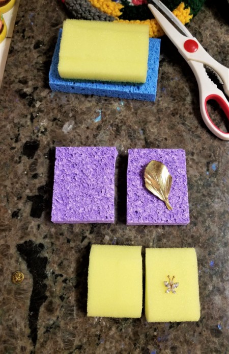 Jewelry protected between two pieces of sponge.