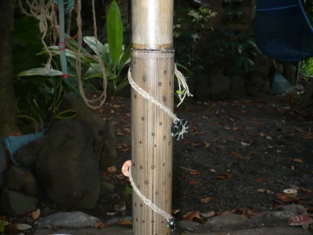 Making a Bamboo Rain Stick - braid some string and decorate the instrument. Be sure to glue the string in place.